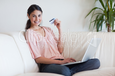 Joyful woman shopping online