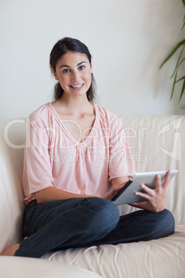 Portrait of a smiling woman using a tablet computer