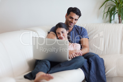 Couple watching a movie while eating popcorn