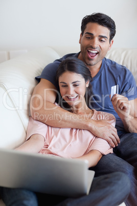 Portrait of a happy couple booking their holidays online
