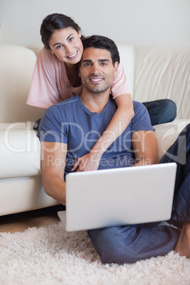 Portrait of a lovely couple using a laptop