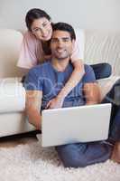 Portrait of a lovely couple using a laptop