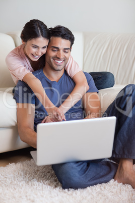 Portrait of a charming couple using a laptop