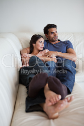 Portrait of a couple lying on a sofa