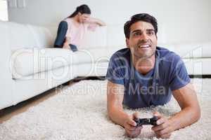Man playing video games while his fiance is crying