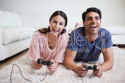 Playful couple playing video games
