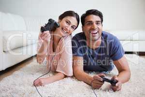 Delighted couple playing video games