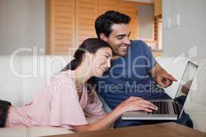 Lovely young couple using a laptop