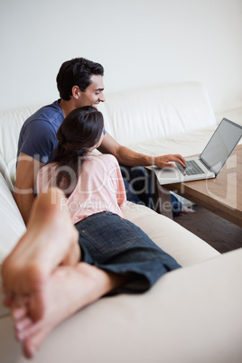 Above view of a couple using a laptop