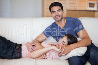 Woman sleeping while his boyfriend is posing