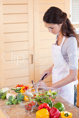 Portrait of a young woman chopping pepper