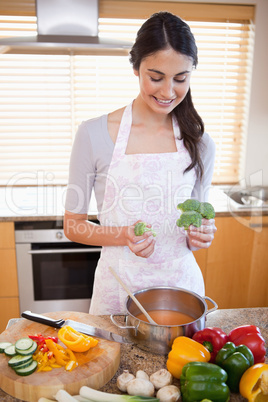 Portrait of a woman cooking a soup