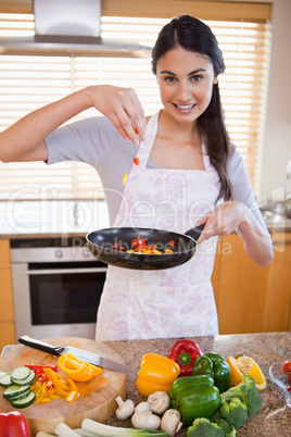 Portrait of a woman preparing a dish