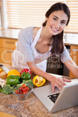 Portrait of a young woman looking for a recipe on the internet