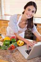 Portrait of a young woman looking for a recipe on the internet