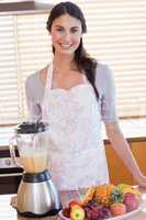 Portrait of a woman posing with a blender