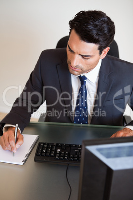 Portrait of a businessman taking notes