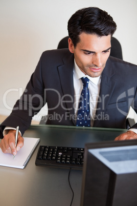 Portrait of a focused businessman taking notes