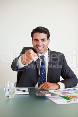 Portrait of a angry businessman pointing at the viewer
