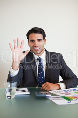 Portrait of a businessman showing his hand