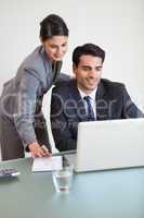 Portrait of sales persons working with a laptop