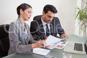 Sales persons working with a notebook