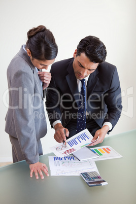 Portrait of focused sales persons studying statistics