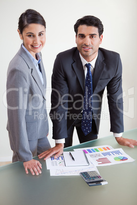 Portrait of smiling sales persons studying their results