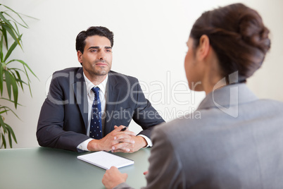 Handsome manager interviewing a female applicant