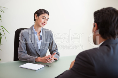 Manager interviewing a good looking applicant