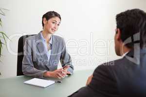 Manager interviewing a good looking applicant