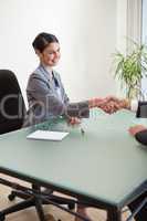 Portrait of a manager shaking the hand of a customer