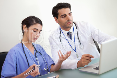 Doctors working with a laptop