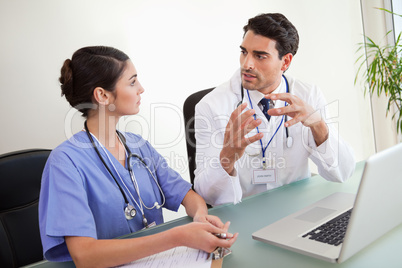 Young doctors working with a laptop