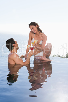 Portrait of a young couple having a cocktail