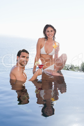 Portrait of a smiling couple having a cocktail