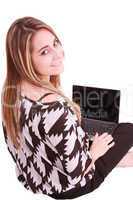 Happy young woman using laptop while sittingg on floor. Isolated