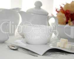 A cup of tea with sugar cubes