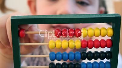 Little girl count on abacus