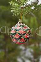 Christmas ball on a branch of pine