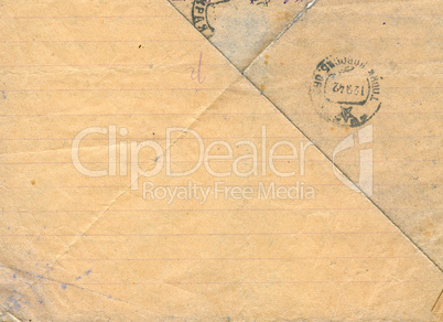 Vintage lined dirty-yellow postal paper with stamps.