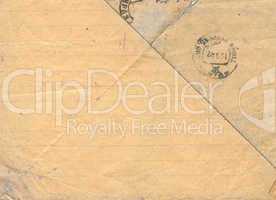 Vintage lined dirty-yellow postal paper with stamps.