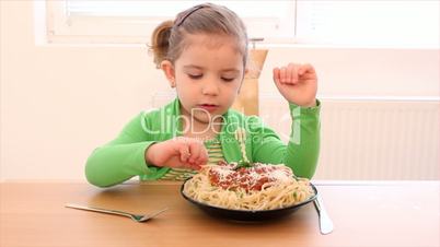 little girl eating spaghetti