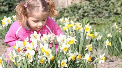 little girl smell flowers