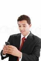 A handsome young business man texting on his phone