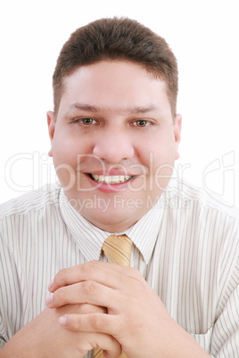 Caucasian man with hands folded in front smiling at viewer.