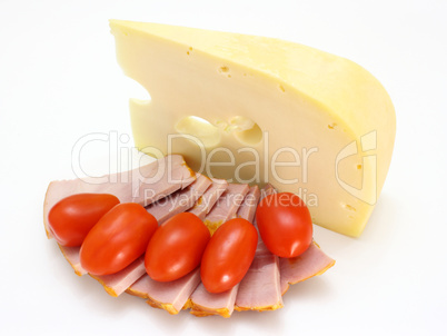 Cheese with holes and red tomatoes