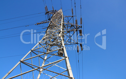 high voltage post against the blue sky