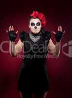 funny woman in day of the dead mask smile on red