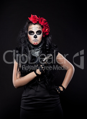 Serious woman in day of the dead mask with gun